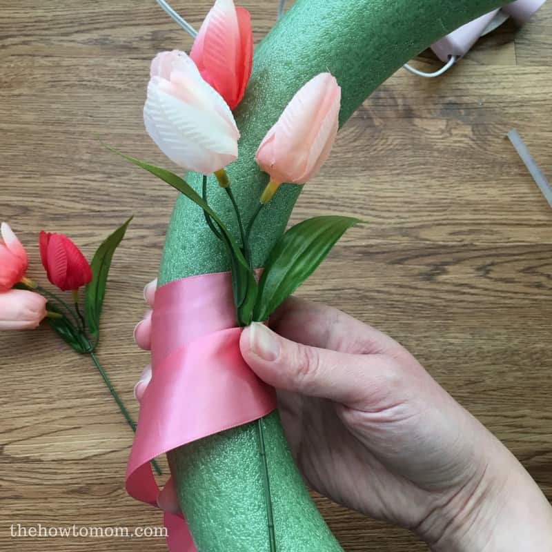 How to make a gorgeous spring tulip wreath - tuck the blooms into the ribbon