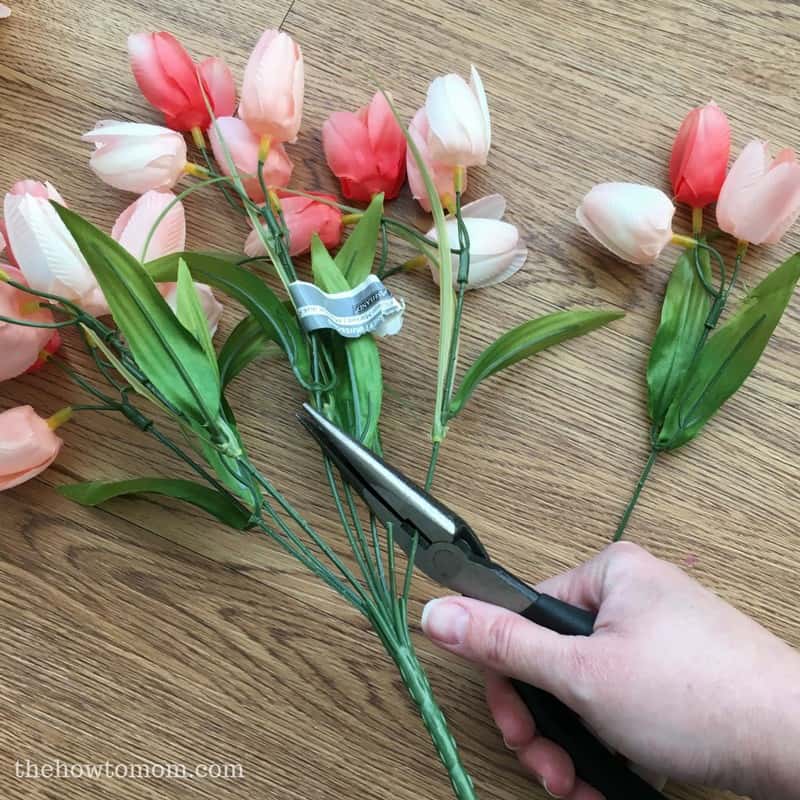 Make your own stunning spring tulip wreath - start by cutting stems off tulip bush