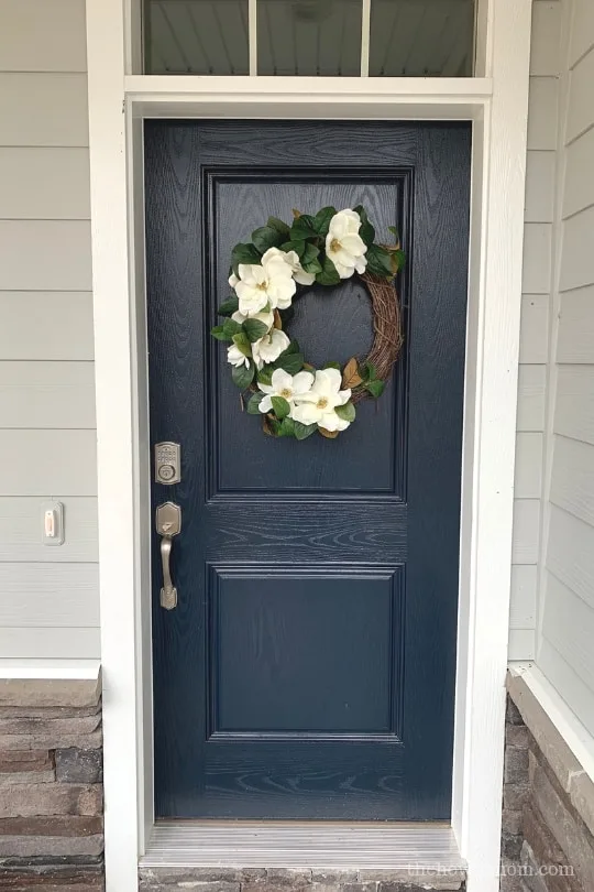 Navy door with magnolia wreath