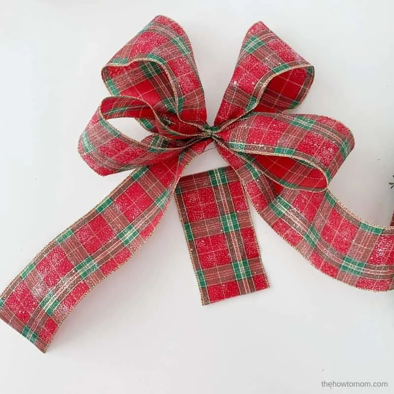 use a piece of ribbon to cover the center of the bow