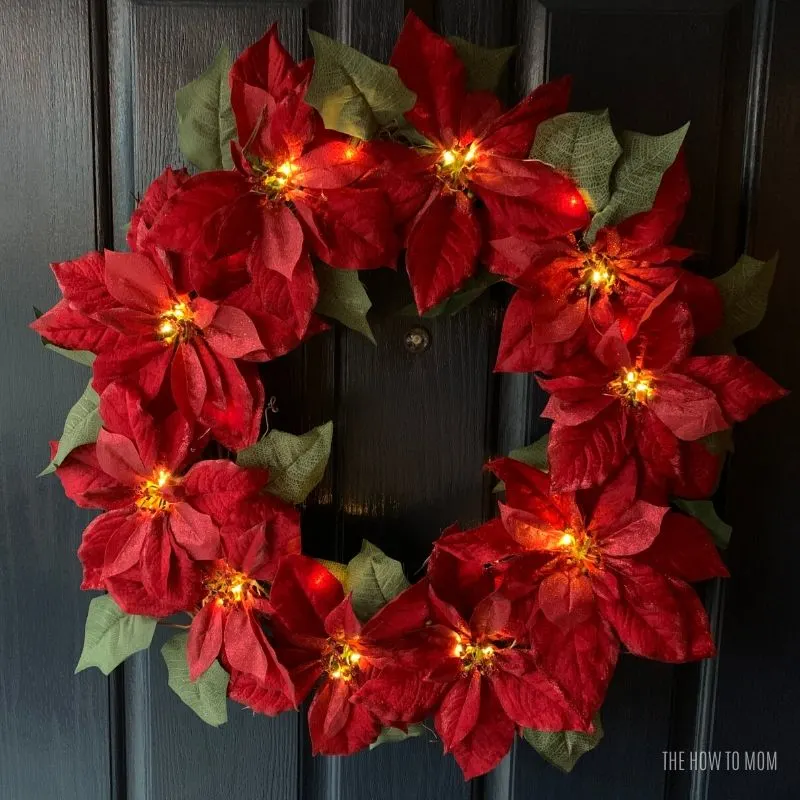 fairy lights on a red poinsettia wreath