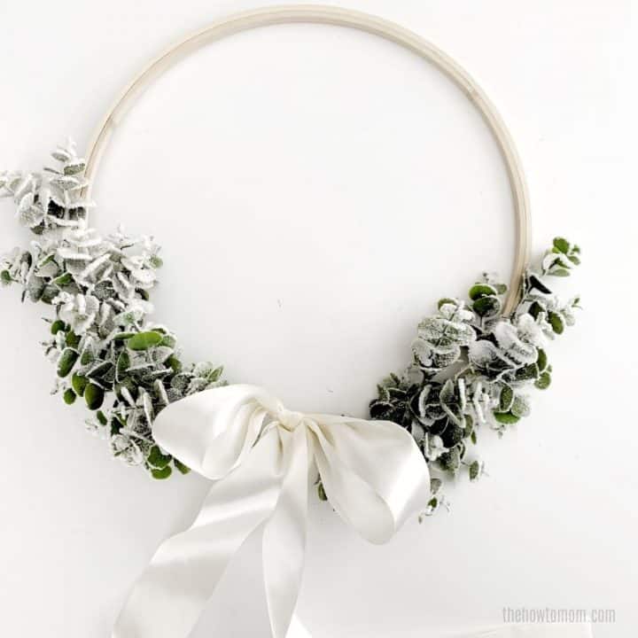 Eucalyptus wreath with flocking and white satin bow