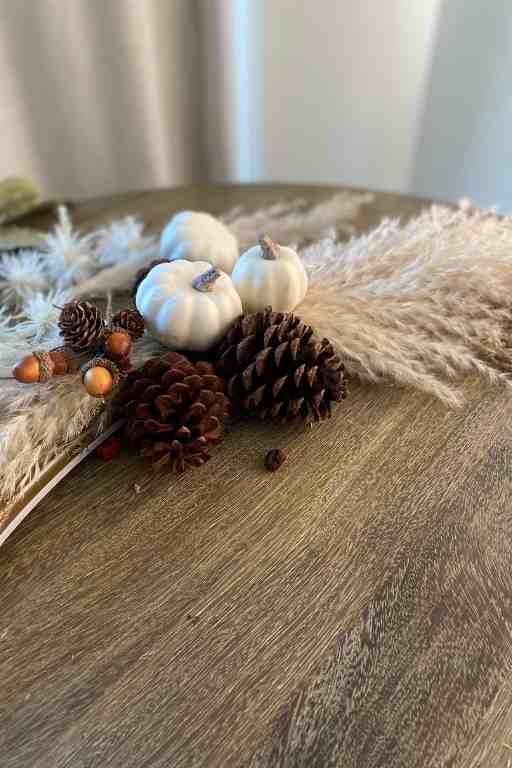 Attach pinecones and pumpkins using glue and wires.