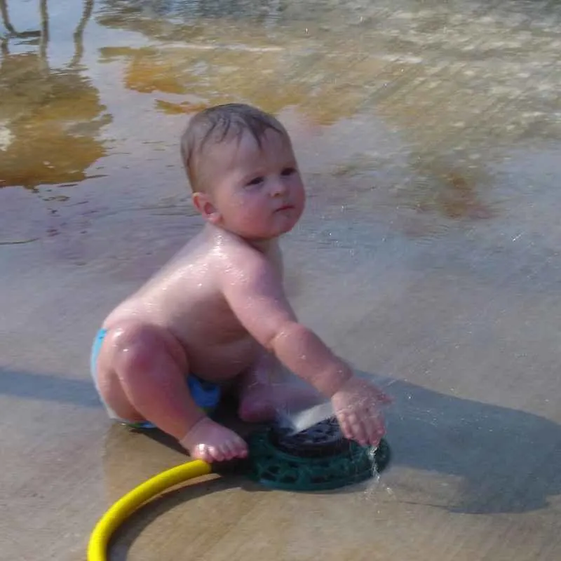 During summer you can make good use of water playtime by giving your toddler a wash-down with baby shampoo outside.
