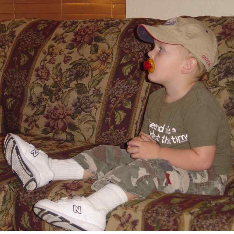 Toddler wearing shoes indoors.