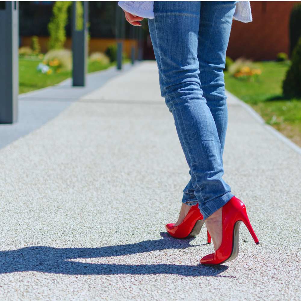 Red high heels add a splash of color when worn with jeans.